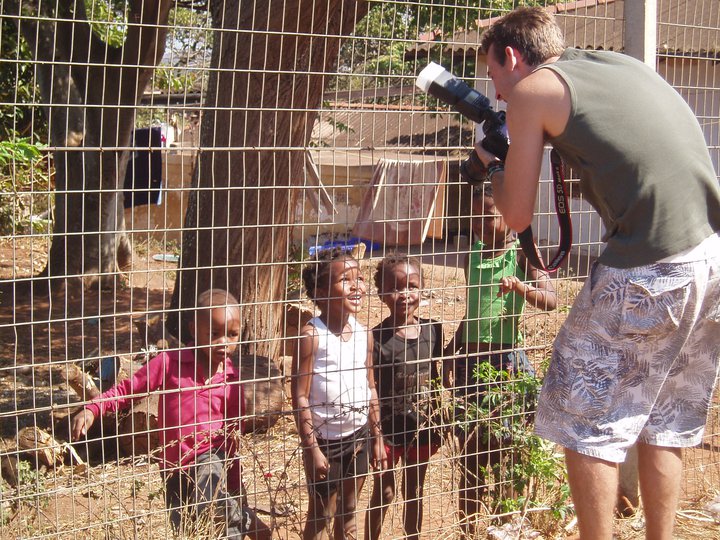 Daniel Bullock taking photos of small African children